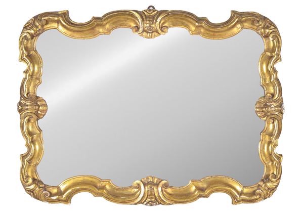 Antique mirror in gilded wood carved with Louis XV motifs, horizontally arched with mercury mirror