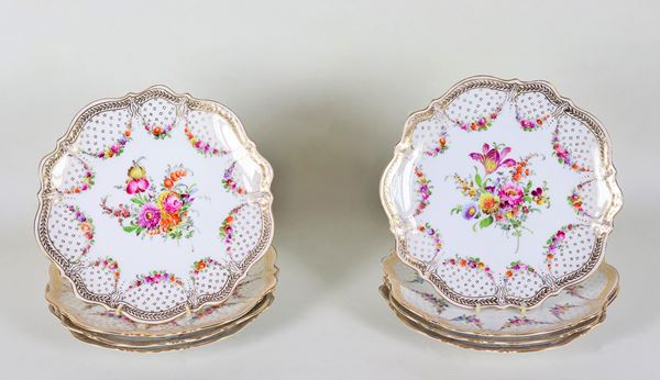 Lotto di otto piattini da dolce in porcellana bianca di Dresda, interamente decorati e variopinti con ghirlande floreali e mazzetti di fiori, lumeggiature in oro zecchino