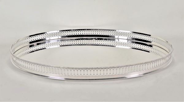 Oval tray in silver-plated metal with a perforated and chiseled railing edge with Louis XVI motifs, one foot missing