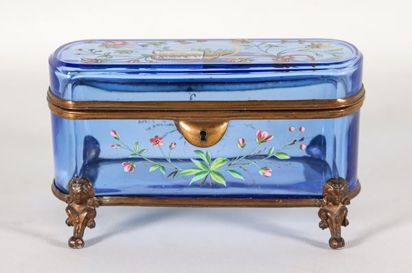 French Art Nouveau box in light blue crystal, with applications of relief enamels with motifs of flowers, leaves and bows, supported by four bronze feet