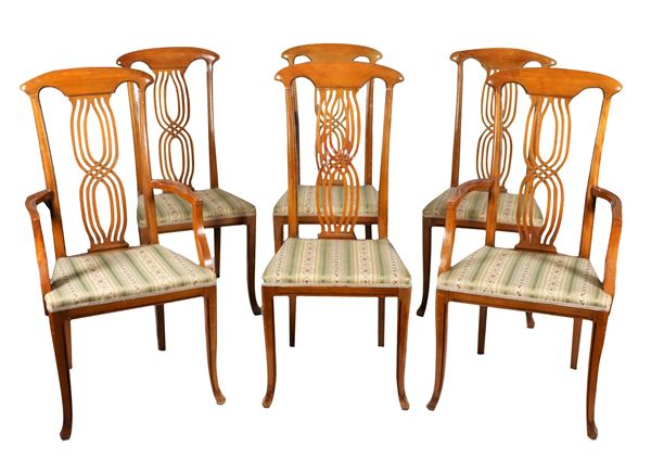 Lot of two arm chairs and four chairs in light mahogany, with woven backs and saber legs, cover in flowery fabric