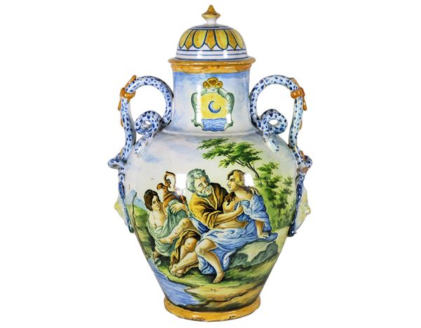 Amphora in glazed and glazed Italian majolica with historical biblical scene, two handles in the shape of snakes with masks