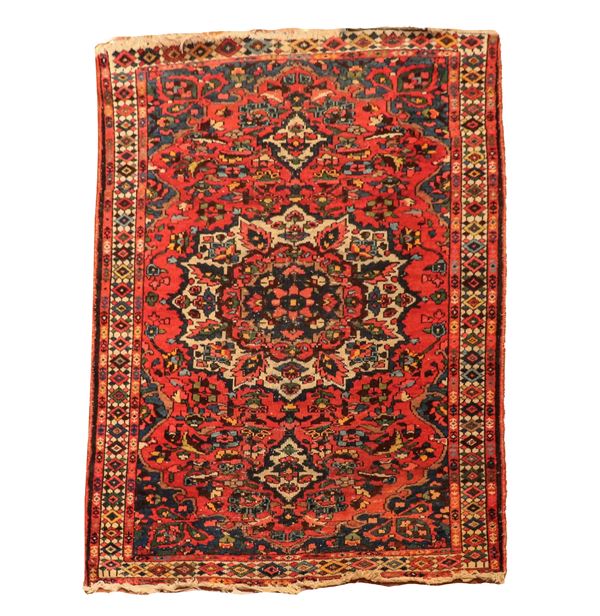 Konia carpet with geometric and floral designs on a red, havana and blue background, M. 1.94 x 1.32