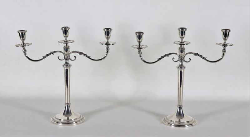 Coppia di candelabri in argento cesellato e sbalzato a motivi Impero, 3 fiamme ciascuno, gr. 1140