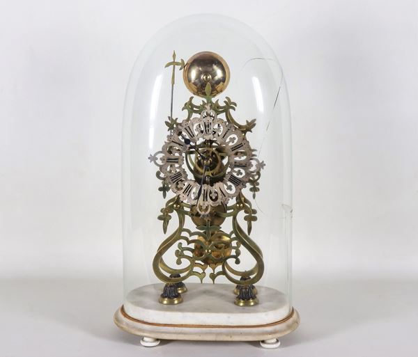 Skeletal table clock in gilded metal, with damaged blown glass bell