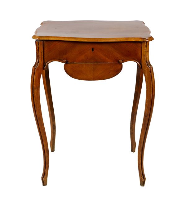 Work table in walnut, with openable top and drawer underneath, four curved legs
