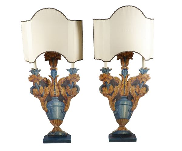 Pair of three-flame floor candle holders, in carved and painted wood with motifs of amphorae and scrolls of acanthus leaves