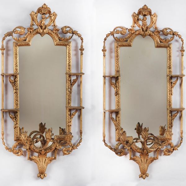 Pair of small Louis XVI Piedmontese mirrors in gilded and carved stucco, with four small porcelain shelves and three flames each