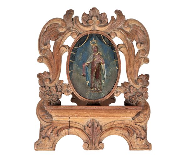 Antique table lectern in carved wood with Louis XV motifs, in the center a small oval painting "Crowned Madonna"