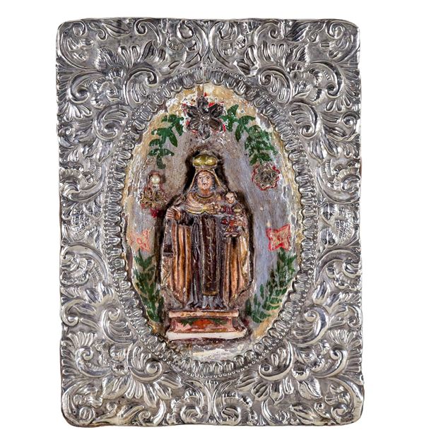 "Madonna con Bambino", antica piccola scultura in cera policromata, in cornice in metallo argentato, sbalzato e cesellato a motivi di volute floreali