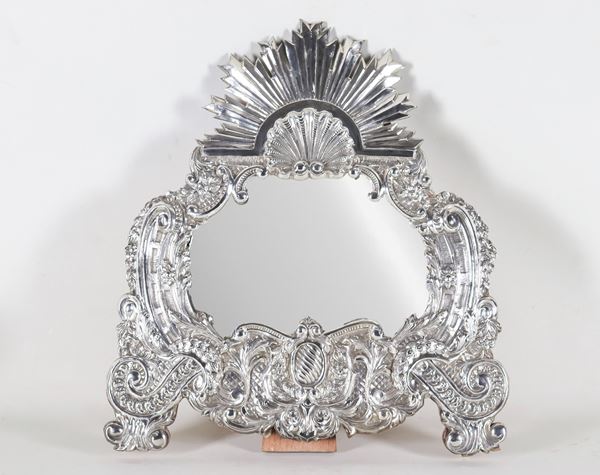 Arched table mirror in South American silver, chiseled and embossed with floral scrolls and shell on the frieze