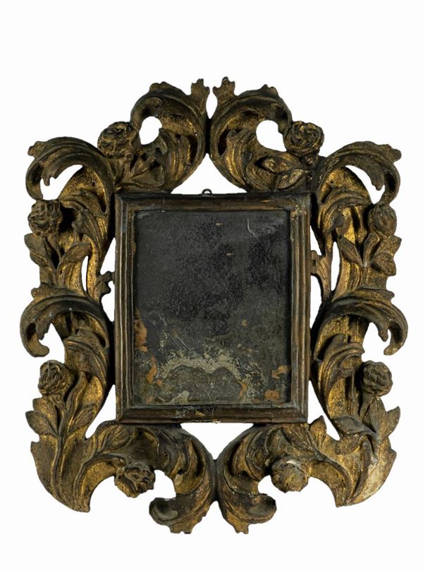 Mirror in gilded wood carved with Louis XIV motifs