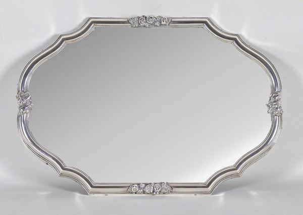 Antique centerpiece in silver with arched oval shape, chiseled and embossed on the edge with motifs of fruit allegories, mirrored background