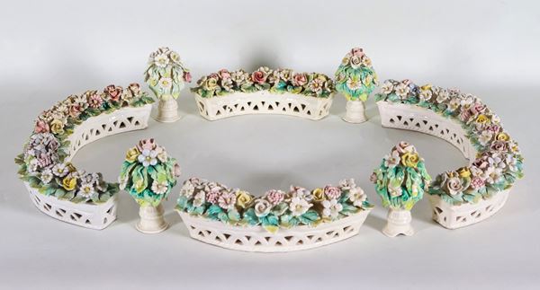 Centerpiece in Capodimonte polychrome porcelain, with six baskets with bunches of flowers in relief and four floral vases (10 pcs)