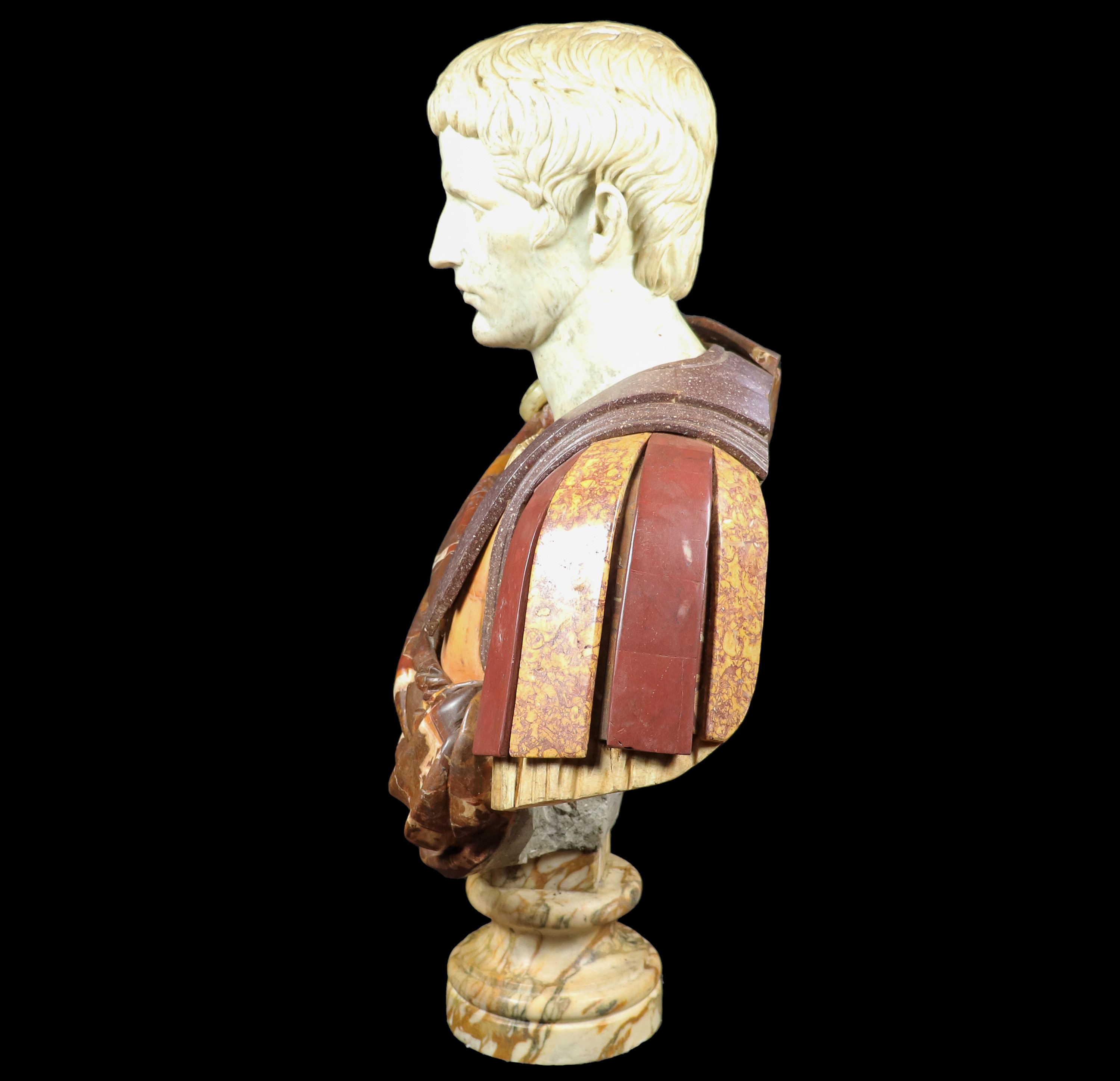 "Imperatore Romano", busto in vari marmi pregiati, base a sezione di colonna tornita