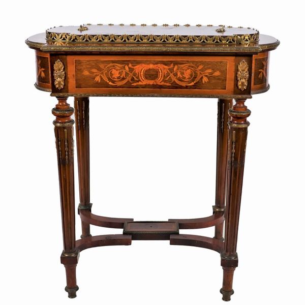 French coffee table with planter, from the Louis XVI line, in mahogany and satin wood with inlays with motifs of floral cords, musical instruments and scrolls, friezes and trimmings in gilded and chiseled bronze and four fluted legs joined by a shaped double cross