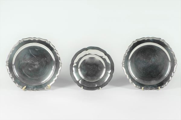 Three round silver saucers
