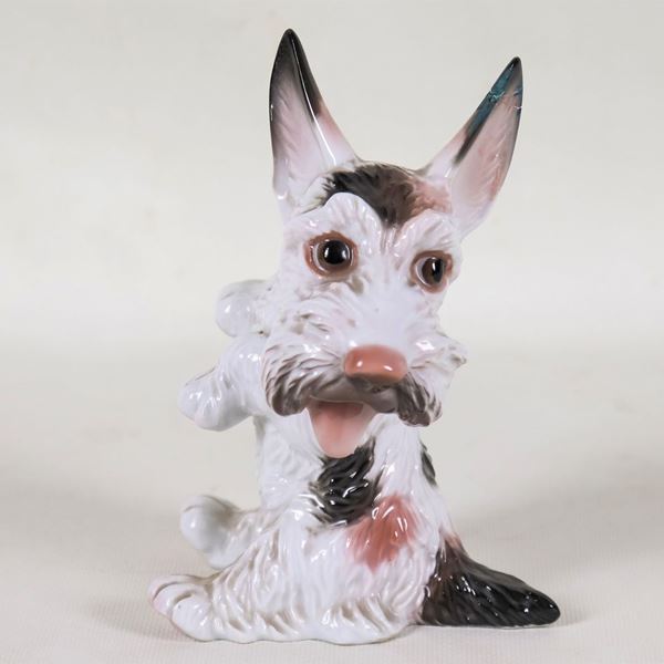 "Dog", small polychrome porcelain sculpture by Rosenthal. The tip of one ear is broken