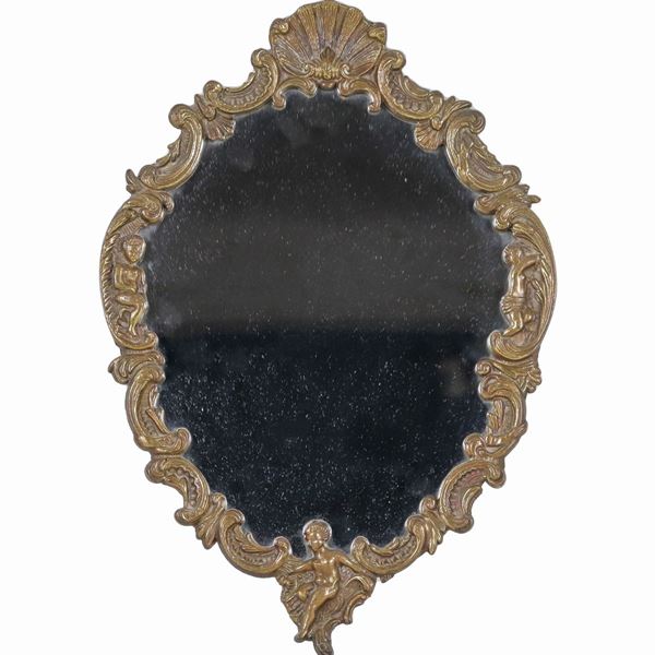 Small oval mirror in gilded bronze, embossed and chiseled with volutes, cherubs and shells