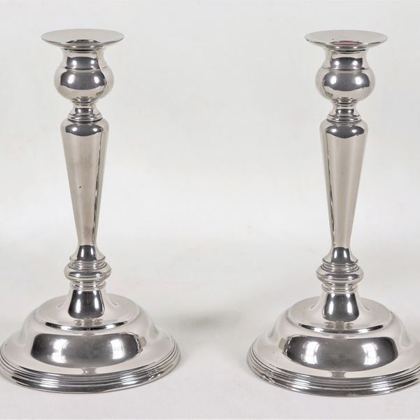 Pair of candlesticks in silvered and embossed metal