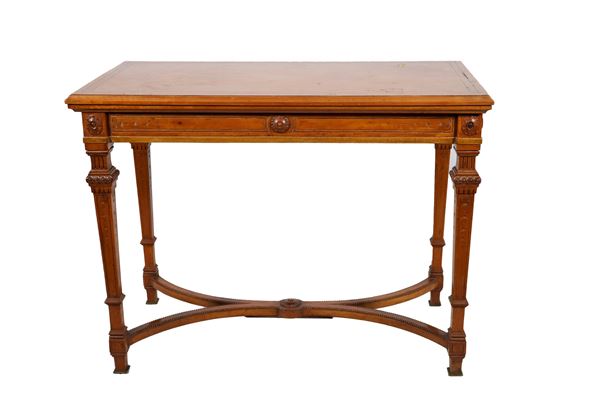 Antique English Louis XVI game table in satinwood, with fillets and carvings with rosette motifs, revolving and folding top with green leather lining inside with gilded borders, four pyramid-shaped legs joined by a shaped crosspiece