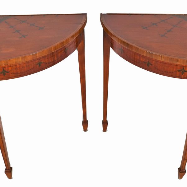 Coppia di consolles inglesi a demi-lune in satinwood, con decori dipinti a motivi Sheraton, tre g...