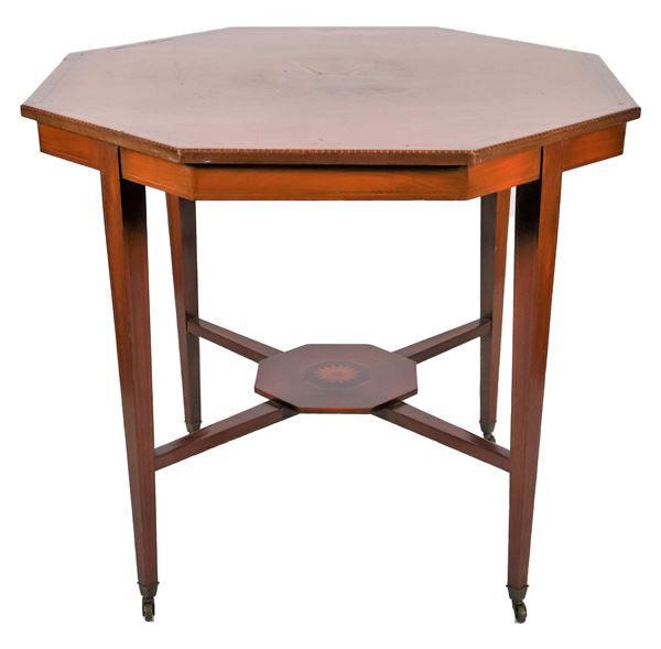 Octagonal center table in satin-finish wood and mahogany, with central rosette motif inlay with leaves, four legs in the shape of an inverted truncated pyramid, joined by a crosspiece surmounted by an inlaid octagonal shelf