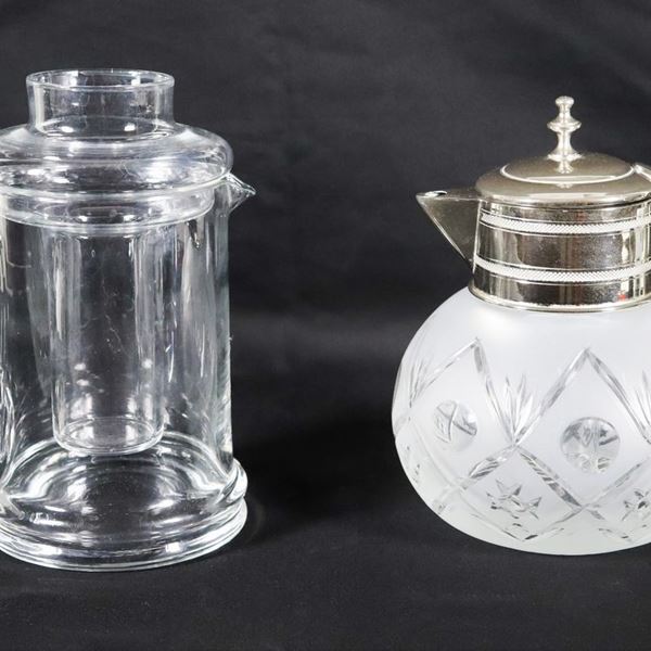 Lot of a crystal thermo jug and a crystal thermo carafe with silver metal neck and handle (2 pcs)