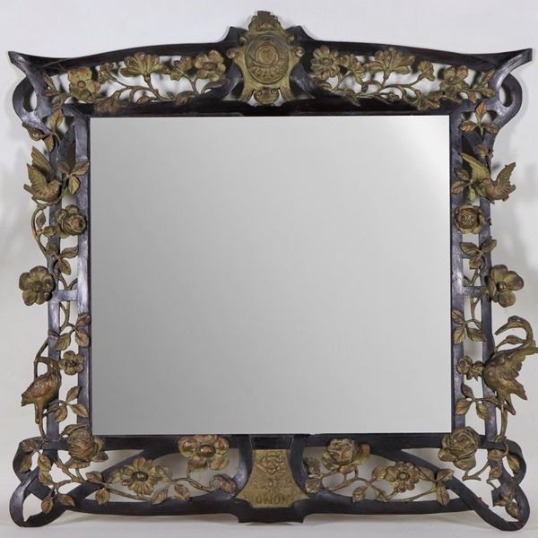 Epoca Liberty mirror in black wood, with intertwining of roses carved in relief in gilded wood