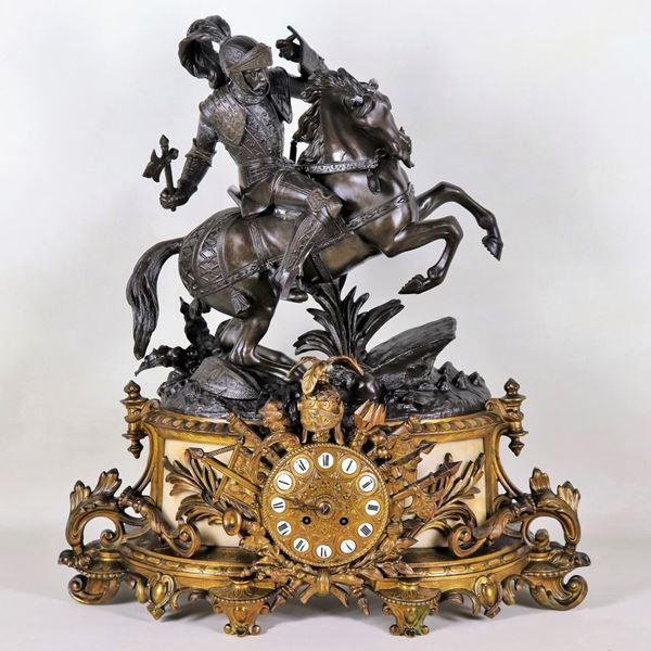 Antique French table clock in gilt and burnished bronze, with sculpture of a knight with armor, gilt dial with Roman numerals in enamel