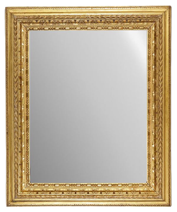 Antique frame in gilded wood and carved with motifs of cords and palmettes, mercury mirror inside