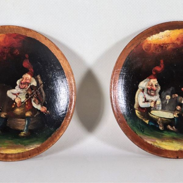 Pair of wooden saucers painted in oil with figures of "Gnomes". Signed