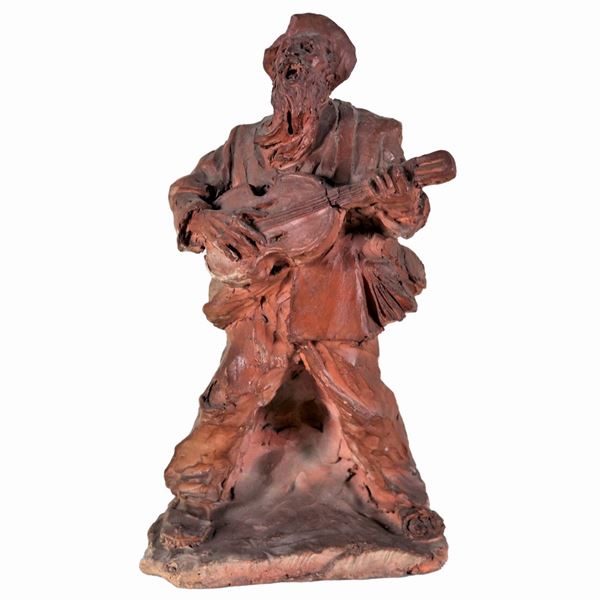 "Suonatore di chitarra", scultura in terracotta napoletana che presenta vari difetti e mancanze