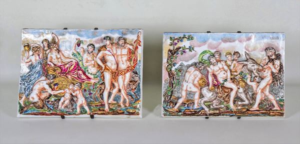 "Mythological scenes", pair of Capodimonte polychrome porcelain tiles, worked in relief
