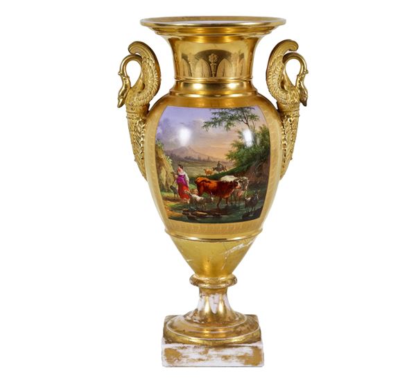Empire period amphora vase in gilded porcelain, with painted squares of "peasant scenes" and handles with sculptures of swans, the base of the vase has damages