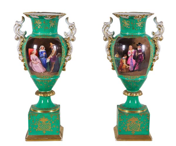 Pair of French amphora vases from the Louis Philippe period (1830-1848), in green porcelain and pure gold with painted squares "Interior scenes with knights and ladies", part of the neck of a vase has an old restoration