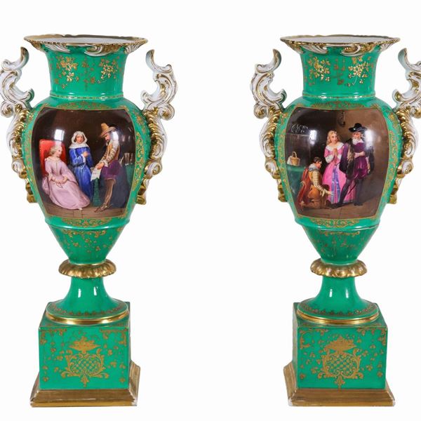 Pair of French amphora vases from the Louis Philippe period (1830-1848), in green porcelain and pure gold with painted squares "Interior scenes with knights and ladies", part of the neck of a vase has an old restoration