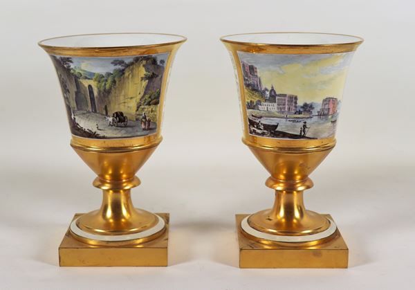 Pair of ancient Neapolitan vases in white and gold porcelain with painted squares "The entrance to the Grotta di Pozzuoli" and "View of Palazzo Donn'Anna in Naples", a part of the inside of the neck of a vase has been restored