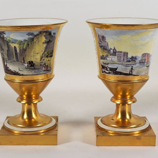 Pair of ancient Neapolitan vases in white and gold porcelain with painted squares "The entrance to the Grotta di Pozzuoli" and "View of Palazzo Donn'Anna in Naples", a part of the inside of the neck of a vase has been restored