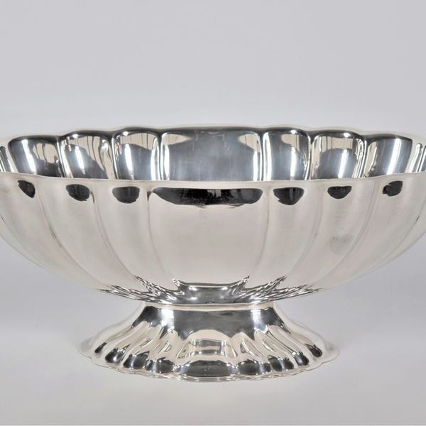 Centerpiece with arched oval shape in embossed and chiselled silver metal with two curved flower-shaped handles