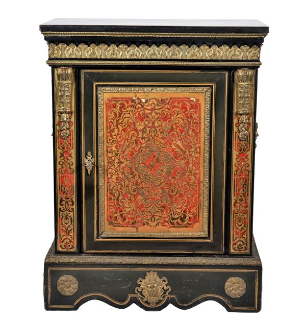 French sideboard with one door from the Napoleon III era (1852-1870), in ebonized wood and Boulle motif inlays with application of gilded bronze friezes, embossed and chiseled with motifs of palmettes, shells and masks