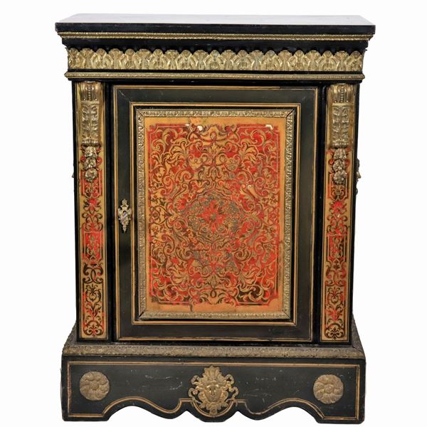 French sideboard with one door from the Napoleon III era (1852-1870), in ebonized wood and Boulle motif inlays with application of gilded bronze friezes, embossed and chiseled with motifs of palmettes, shells and masks