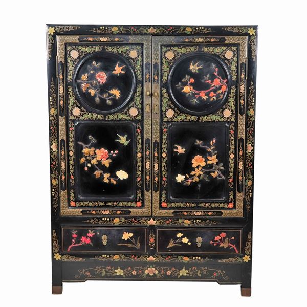 Japanese cabinet in black lacquered wood, with decorations and applications of semi-precious stones and jades, two doors and two drawers underneath