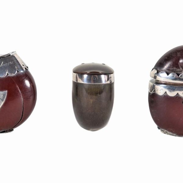 Lot of three English snuff mulls, one in curved goat horn and two in horse chestnut shells, one of which with silver trimmings. Shell defects