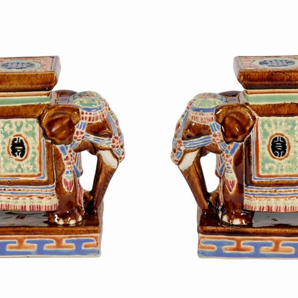 Pair of porcelain elephants, entirely decorated with polychrome enamels in relief