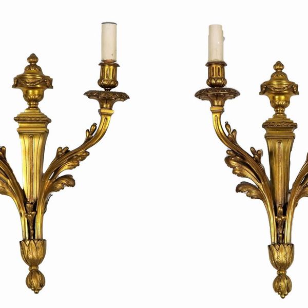 Coppia di appliques francesi in bronzo dorato, cesellato e sbalzato a motivi Luigi XVI di anfore e foglie, 2 luci ciascuna