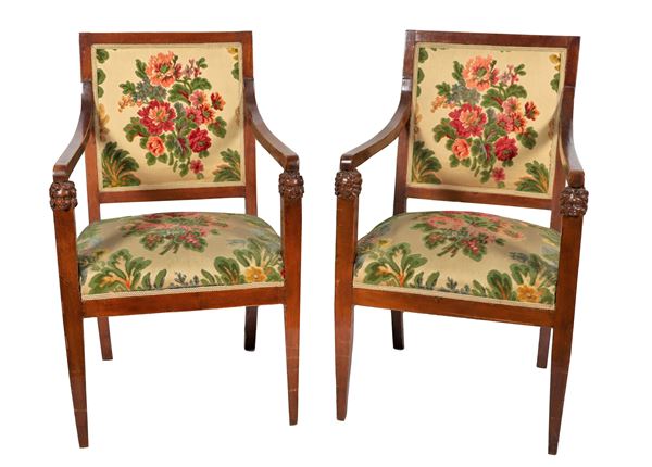 Pair of Empire period armchairs in walnut, with lion heads on the armrests and cover in floral fabric