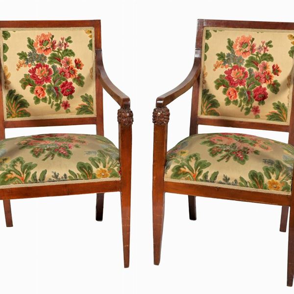 Pair of Empire period armchairs in walnut, with lion heads on the armrests and cover in floral fabric