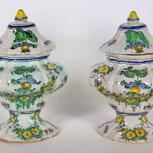 Pair of antique vases with lids in Pesaro glazed majolica, with colorful decorations of leaves, flowers and butterflies
