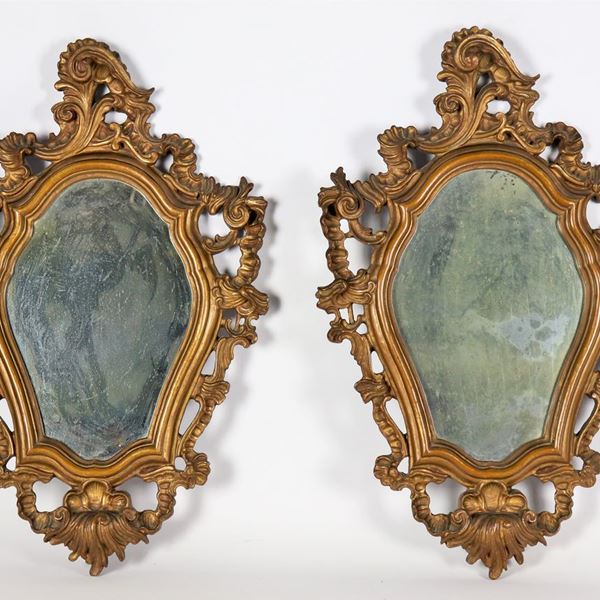 Pair of small mirrors in gilded and carved wood with Louis XV motifs, mercury mirrors